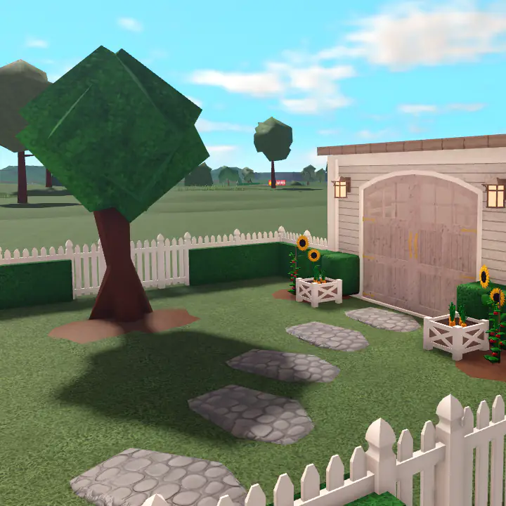 Back garden featuring a tree and a stone path